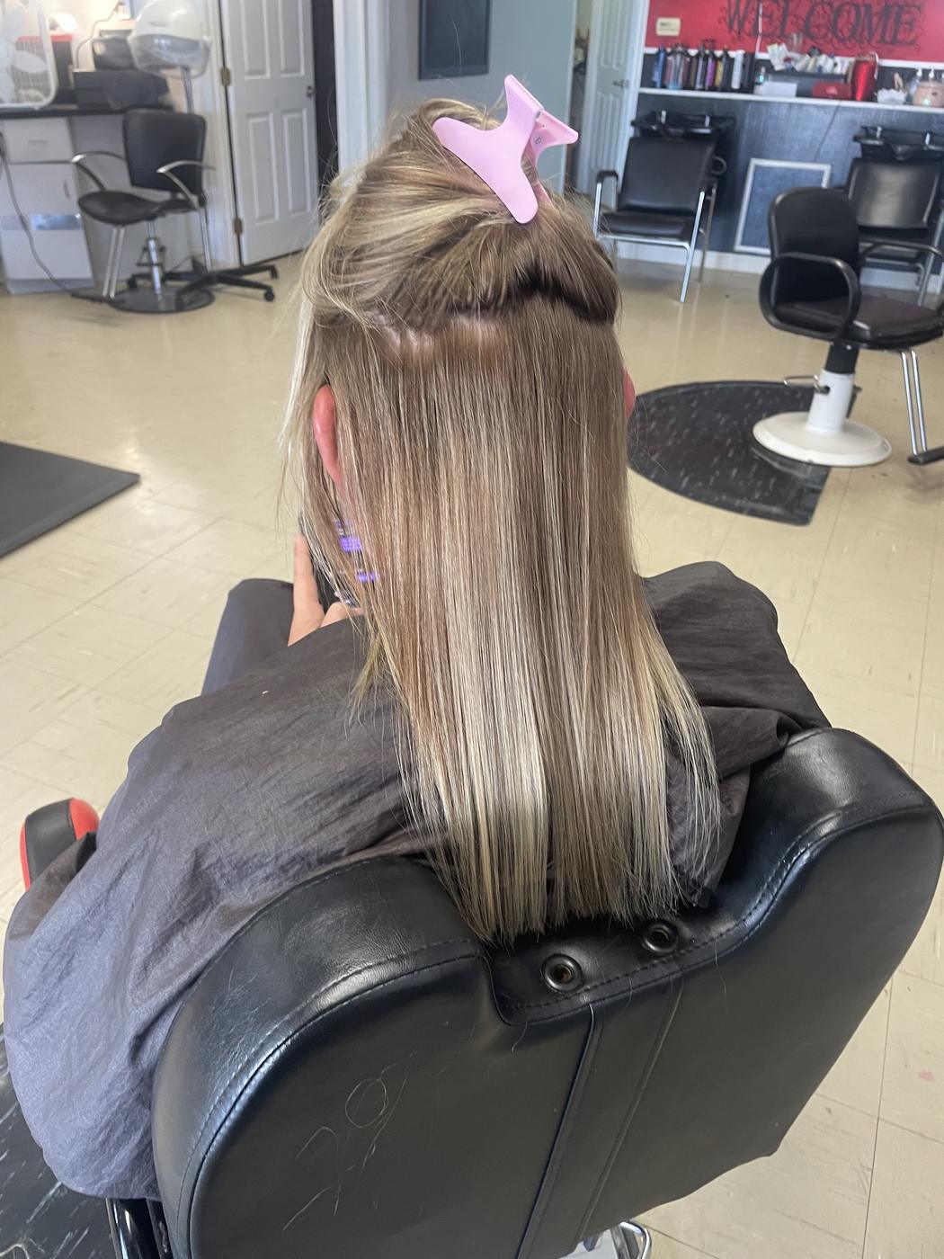 Hair extension work in progress, with the full Levels Up salon visible