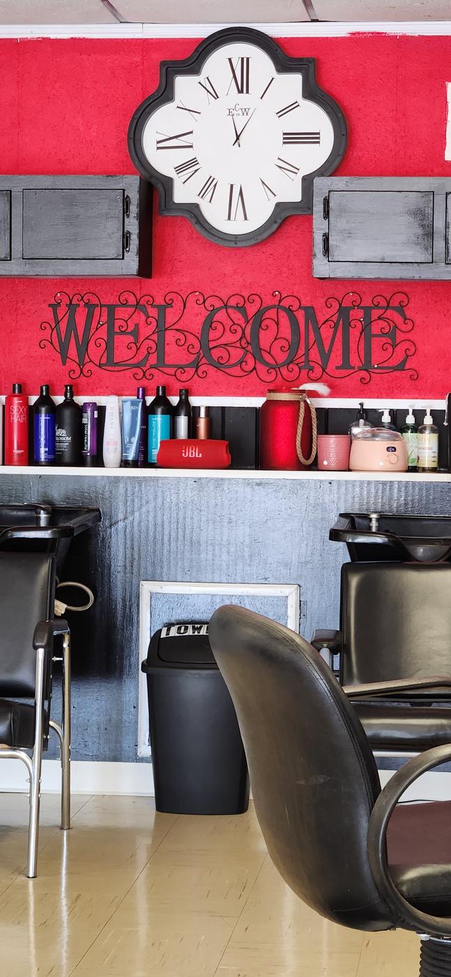 A close-up of the WELCOME wall art and product shelf at Levels Up